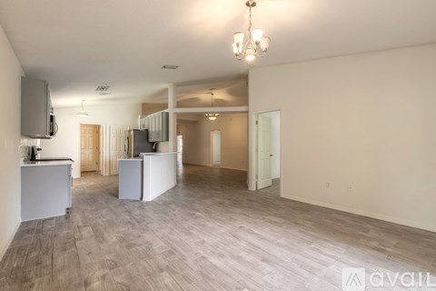 A spacious living room with a television and a cabinet.