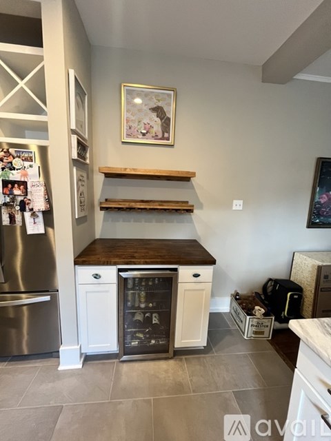 A kitchen with a white fridge, a white dishwasher and a white oven.