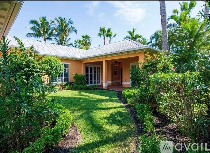 A house with a garden in front of it is for sale.