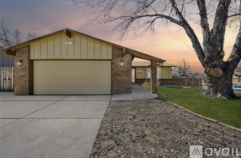 A house with a garage and a driveway is available for sale.