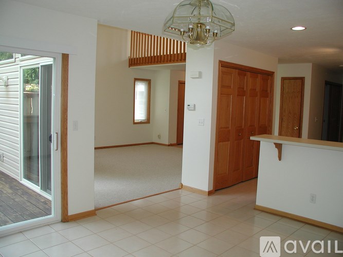 A large open room with a chandelier and a white floor.