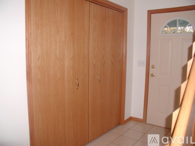 A wooden double door with a glass window above it.