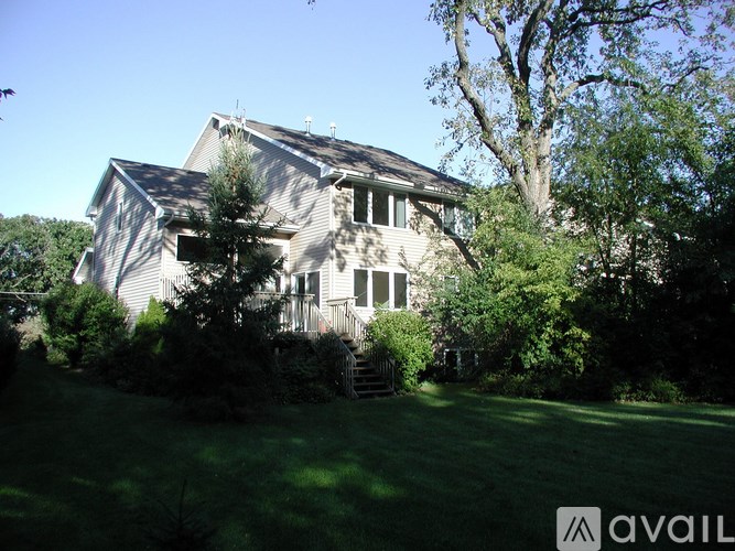 A house with a tree in front of it.