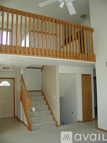 A room with a staircase and a balcony.