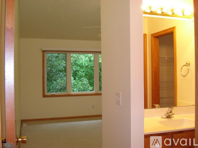 A bathroom with a window and a sink.