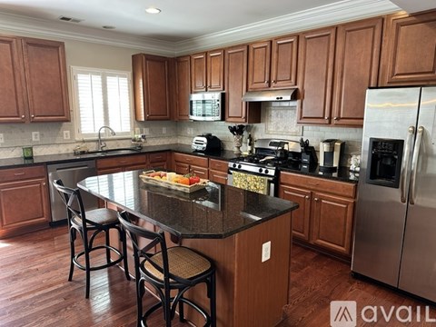 A kitchen with wooden cabinets and a black countertop.