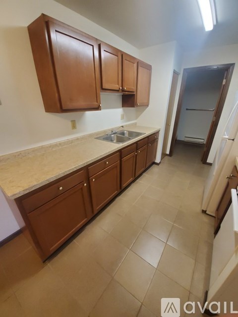 A kitchen with brown cabinets and a countertop.