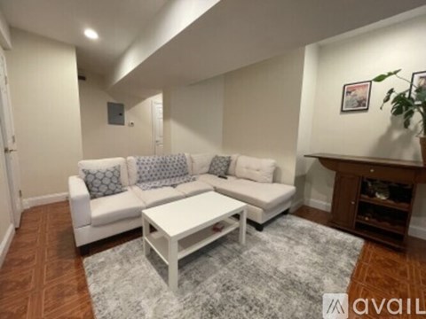 A living room with a white couch and a coffee table.