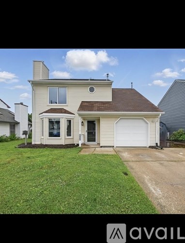 A house with a brown roof and a white garage door.