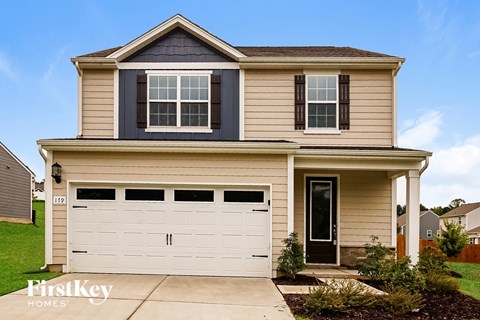 A two-story house with a garage and a front porch.