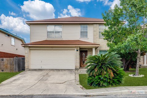 A house with a brown roof and a garage door.