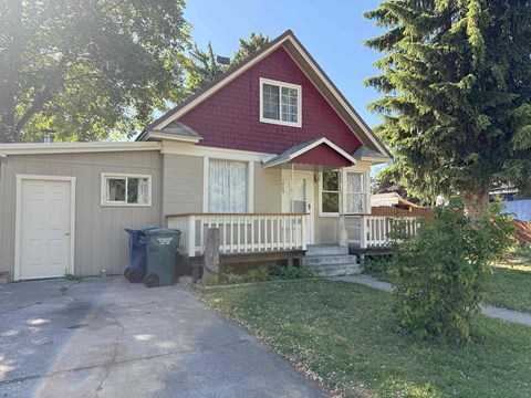 A house with a red roof and a white garage door.