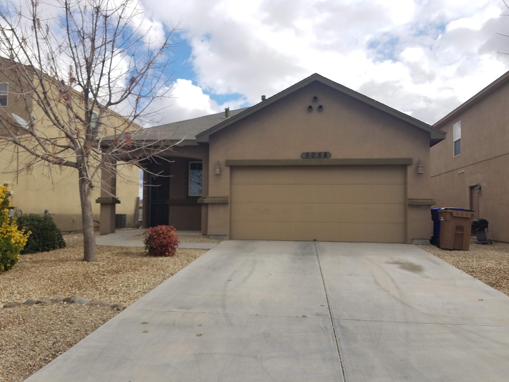 A house with a driveway in front of it.