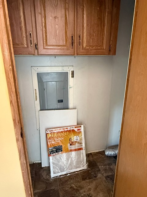 A kitchen with wooden cabinets and a white fridge.