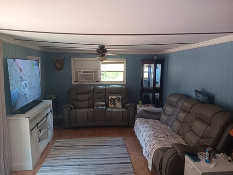 A living room with a grey sofa and a television.