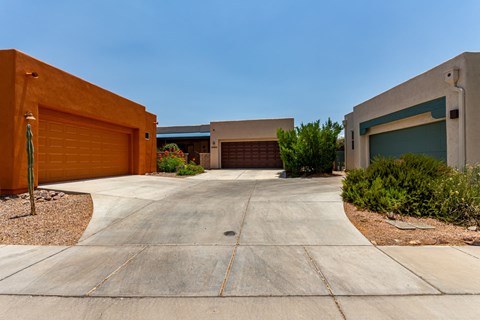 A modern house with a driveway and garage doors.