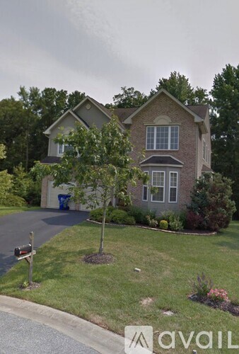 A house with a tree in front of it.