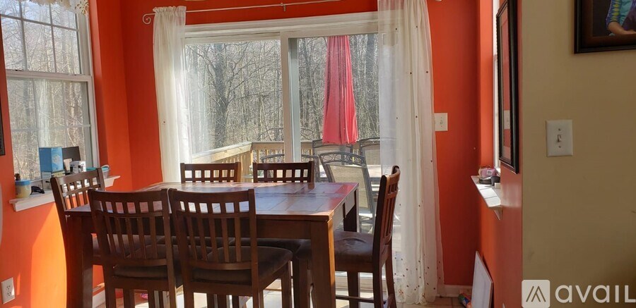 A dining room with a table and chairs.