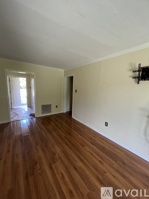 A room with wooden floors and a white ceiling.