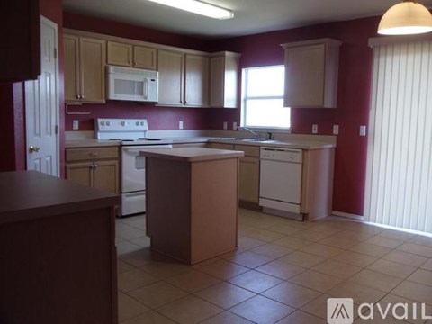 A kitchen with a white stove and white oven.