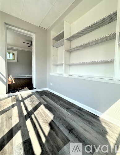 A room with a grey floor and white walls.