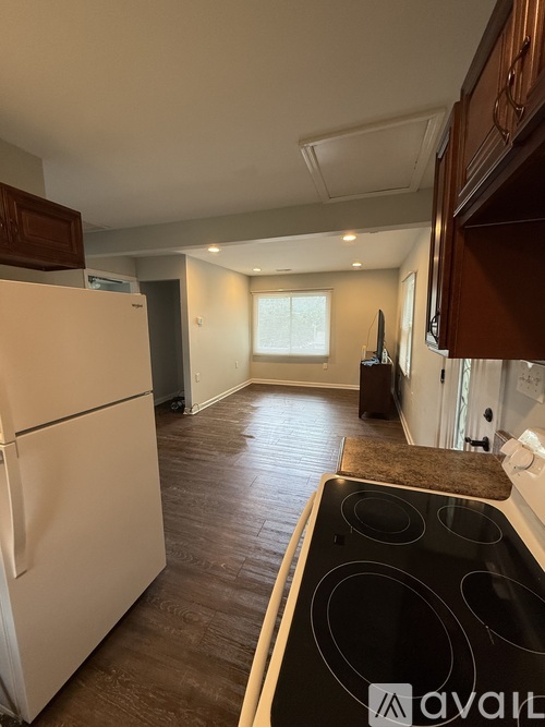 A living room with a washing machine placed in it.