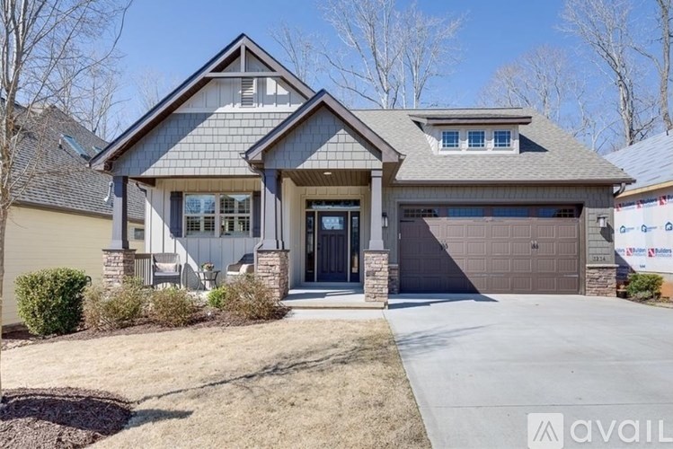 A house with a garage and a driveway is available for sale.