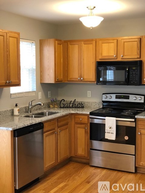 A kitchen with wooden cabinets and stainless steel appliances.