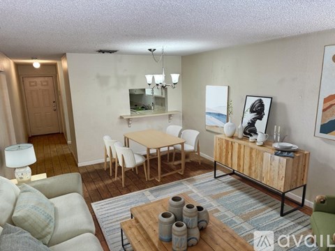A living room with a wooden table and chairs.