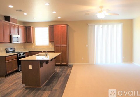 A kitchen with brown cabinets and a white countertop.