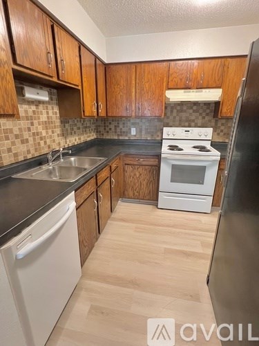 A kitchen with wooden cabinets and a white oven.