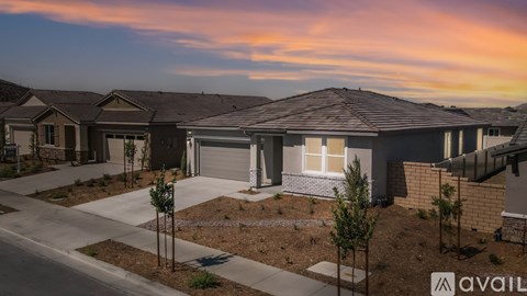 A row of houses with the word AVAILABLE on the front of the first one.