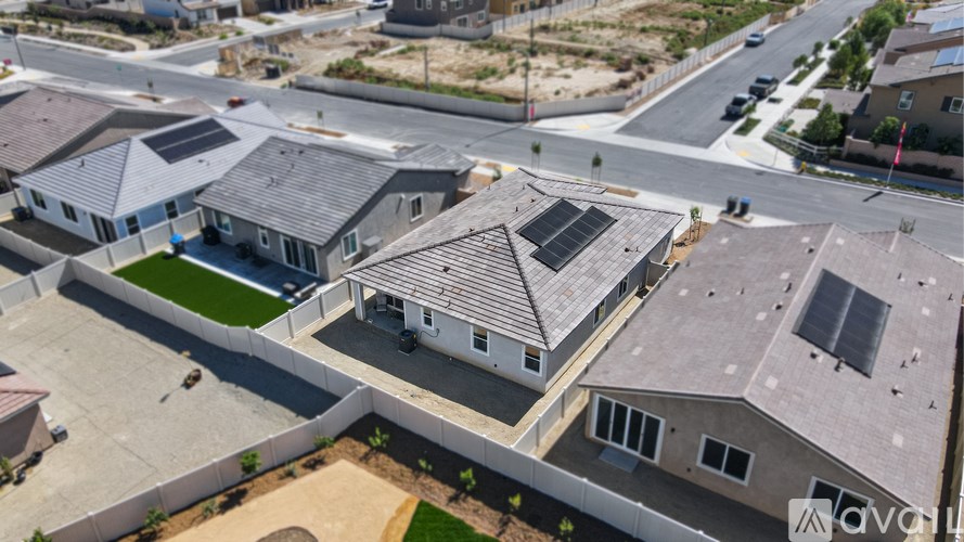 A bird's eye view of a residential area with houses and roads.