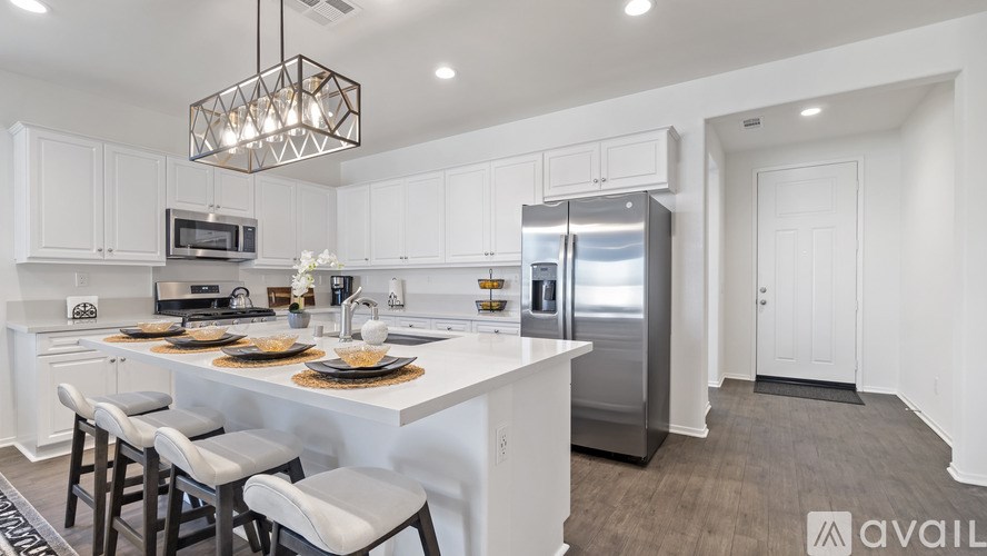 A modern kitchen with white cabinets and a center island.