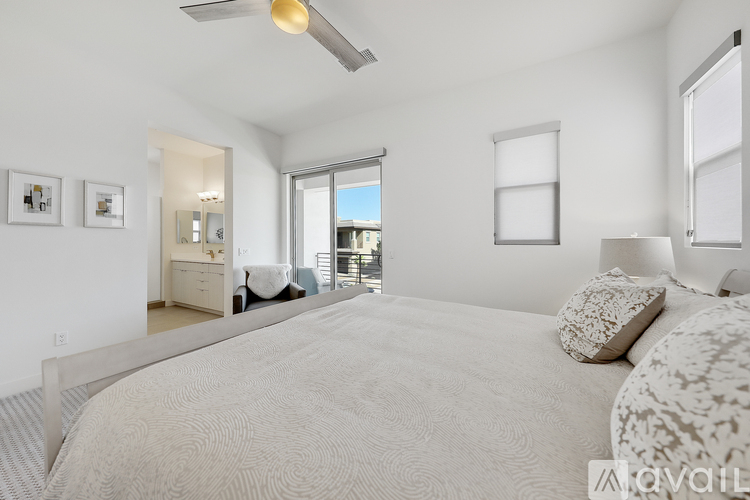 A bedroom with a large bed and a view of the outside.