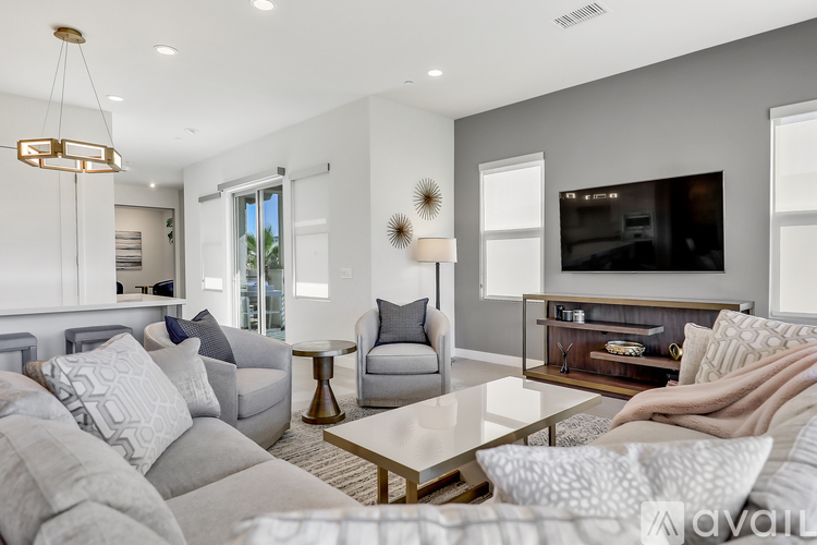 A modern living room with a grey couch and a coffee table.