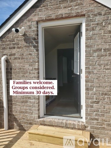 A sign on a house reads "Families welcome. Groups considered. Minimum 30 days."