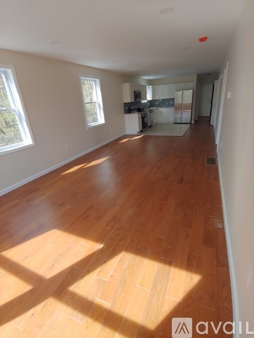A room with wooden floors and white walls.