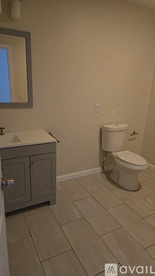 A bathroom with a toilet and a sink.