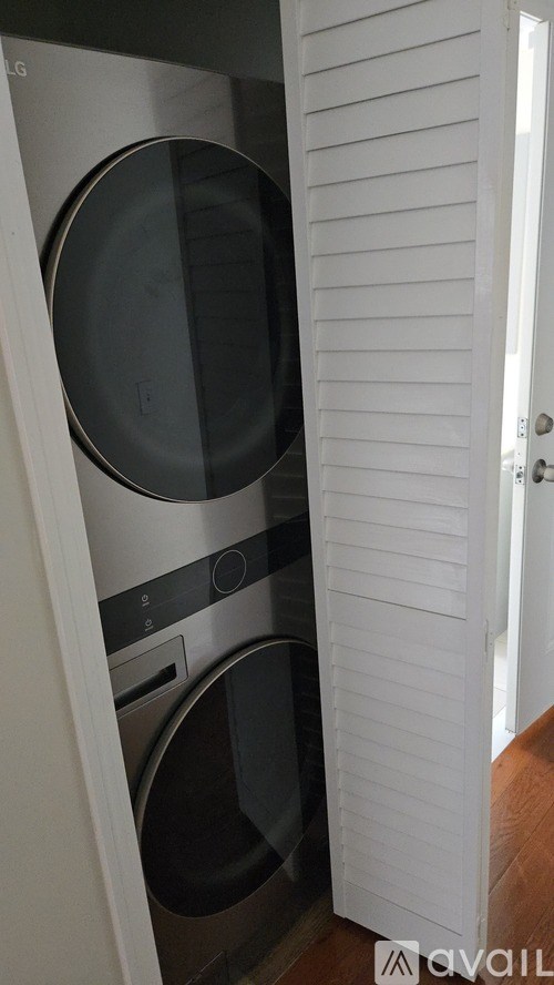 A room with wooden flooring and a window.