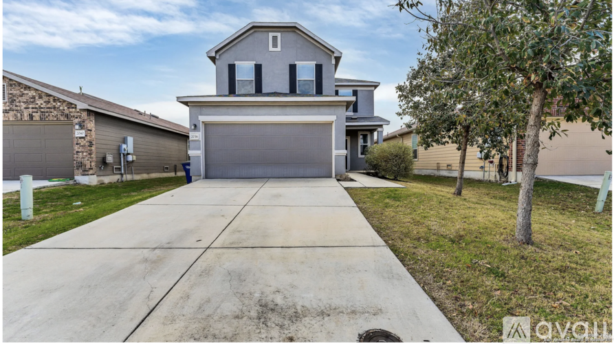 A two-story house with a garage is for sale.