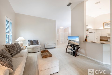 A living room with a television and a couch.