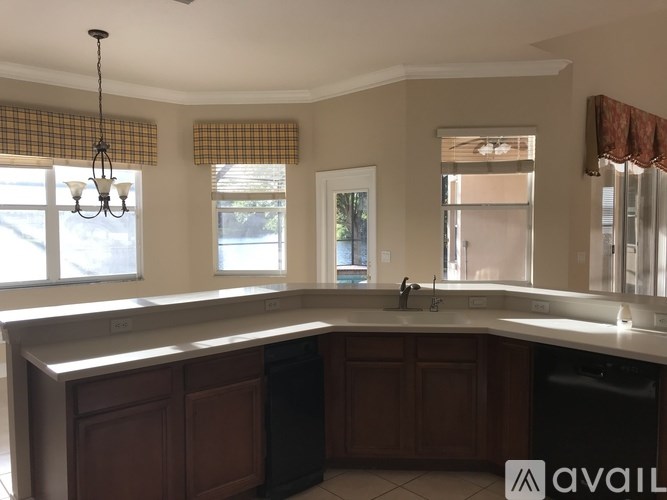 A kitchen with brown cabinets and a white countertop.