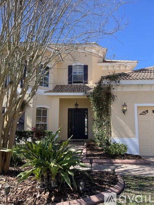 A house with a black front door and a white garage door.