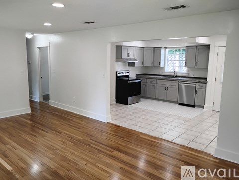A kitchen with white cabinets and a black dishwasher.