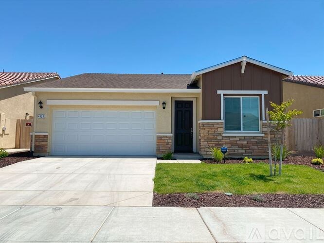 A house with a brown roof and a white garage door.