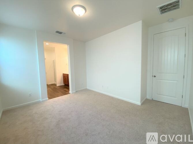 A room with white walls and a carpeted floor.