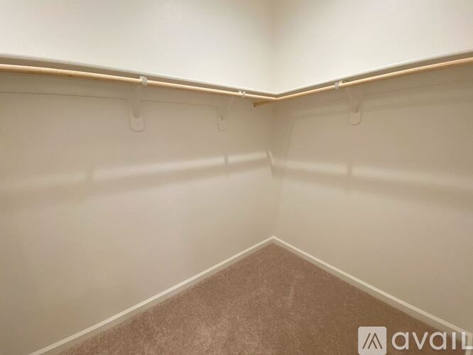 A room with a carpeted floor and white walls.