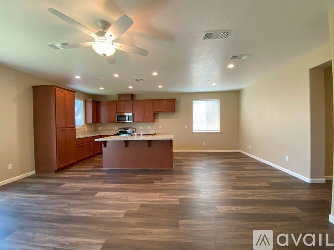A spacious kitchen with wooden cabinets and a central island.