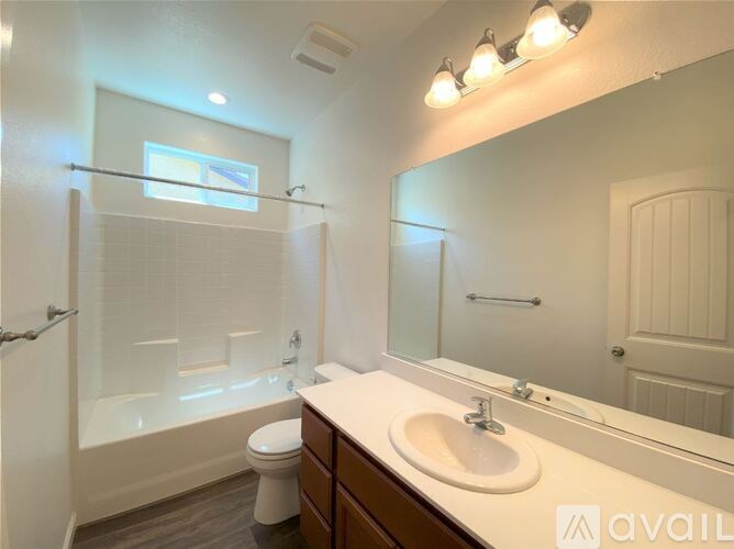 A bathroom with a toilet, sink, and shower.